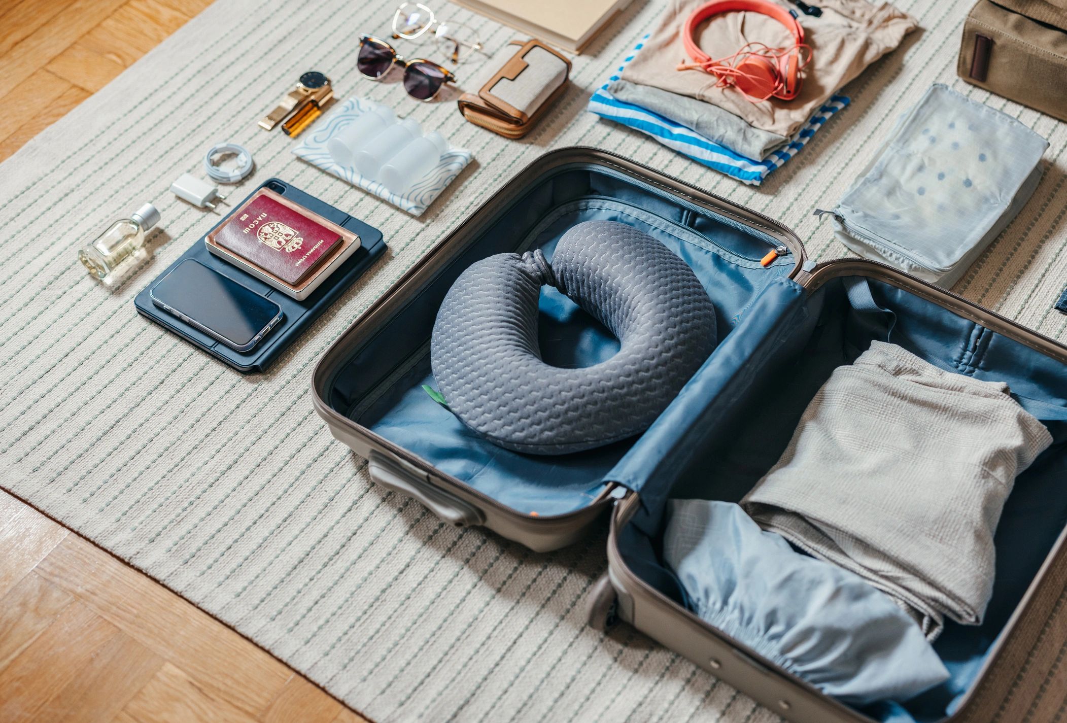 Travel essentials including passport and luggage prepared for an international trip
