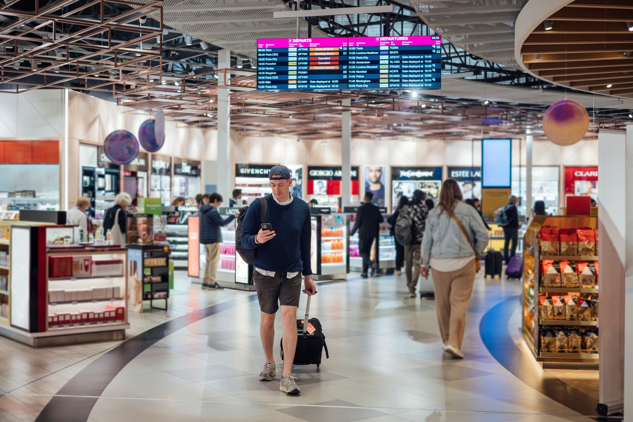Professional traveler walking through an airport terminal with luggage