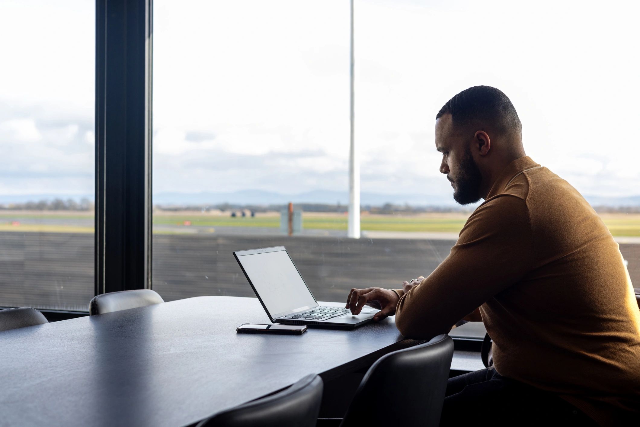 Professional traveler working in an airport lounge