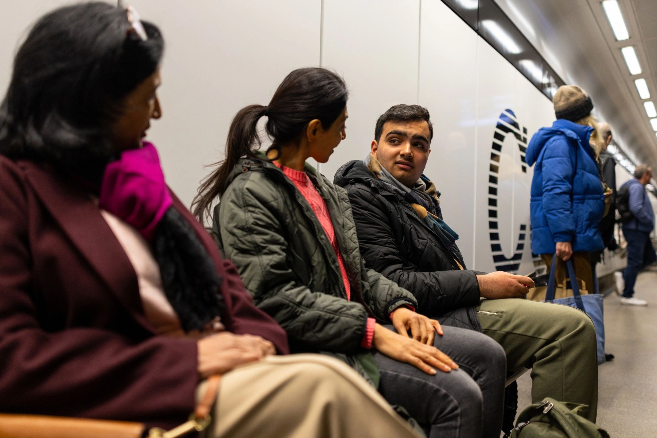 Travelers waiting in a modern station, representing international journeys
