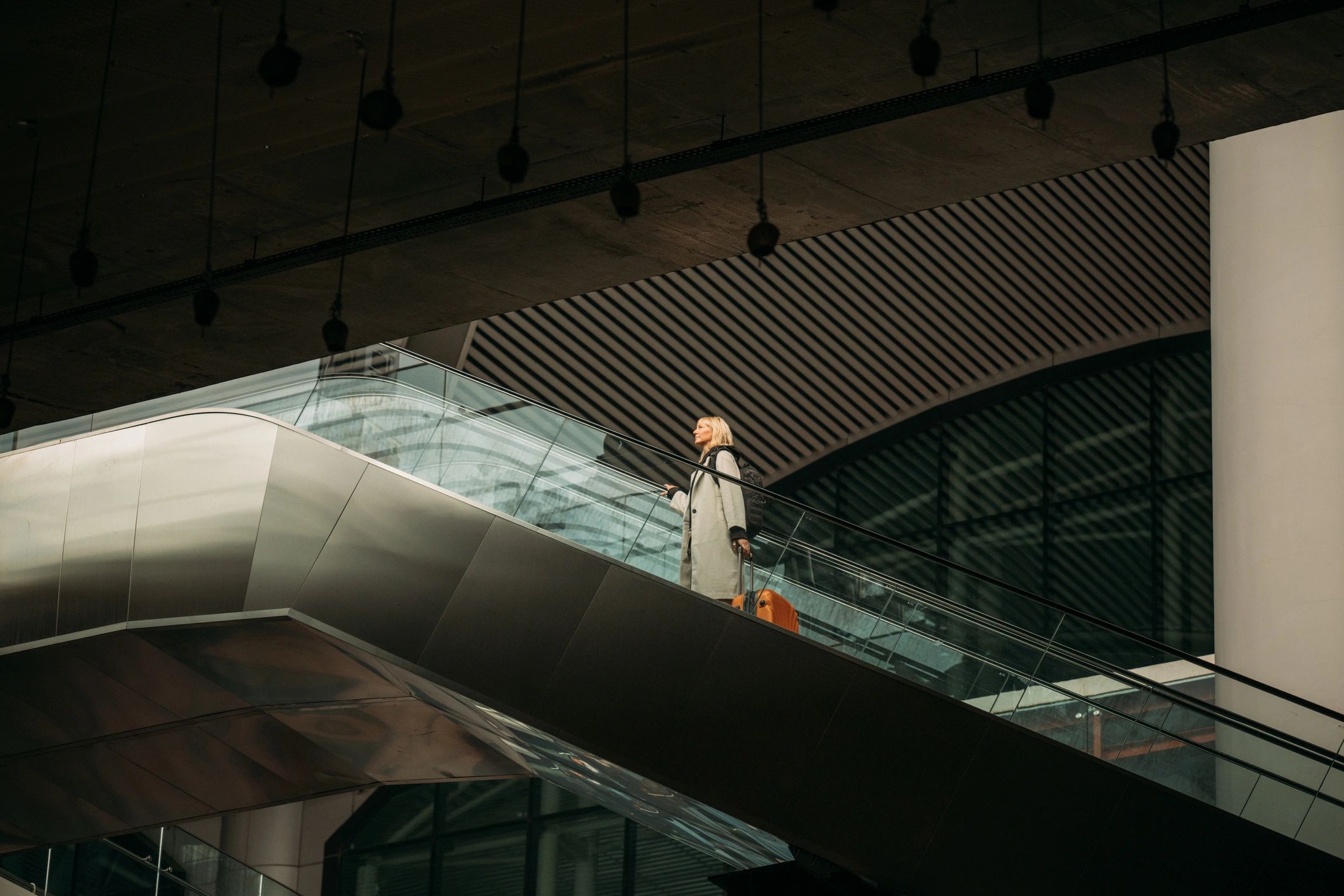 Traveler moving through a modern airport terminal